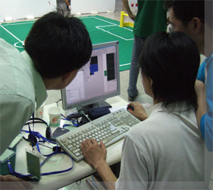 (WrightEagleUnleashed! team members enhancing the robots' strategy)